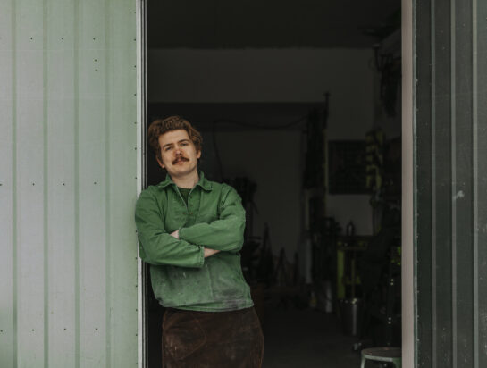 Portrait of blacksmith standing in entrance to workshop